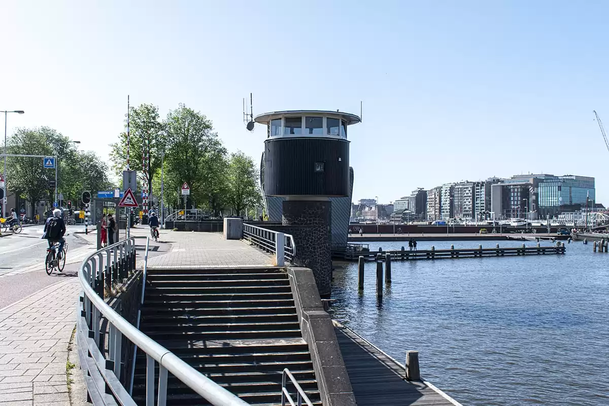 Photo of SWEETS hotel Amsterdam Centre bridge house Kortjewantsbrug exterior cyclists water view architecture