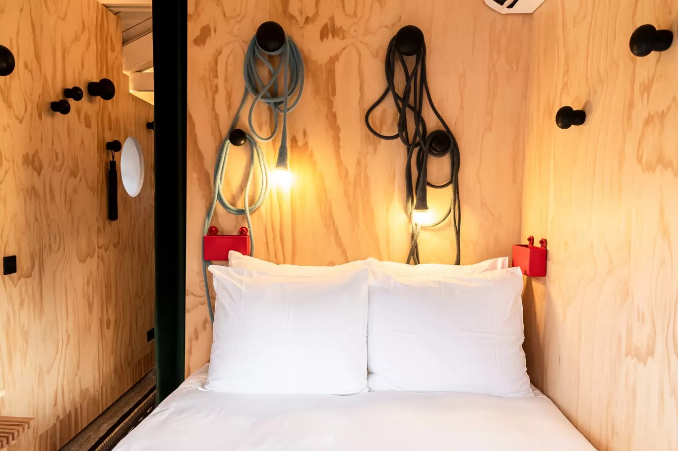 Bed and interior of SWEETS hotel's bridge house Omvalbrug