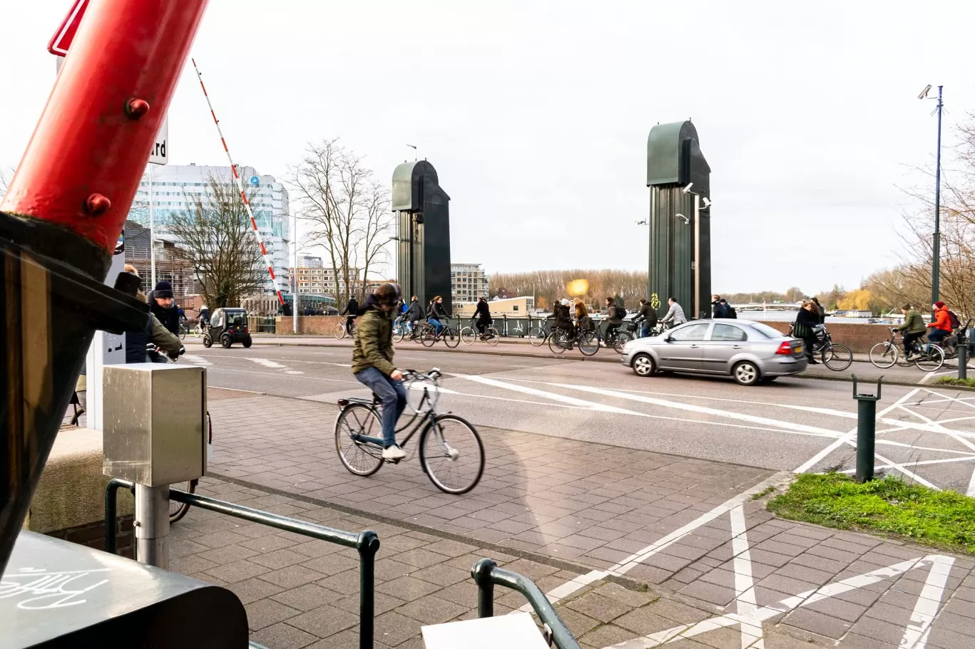 Street and bridge with cyclists as seen from SWEETS hotel's bridge house Omvalbrug
