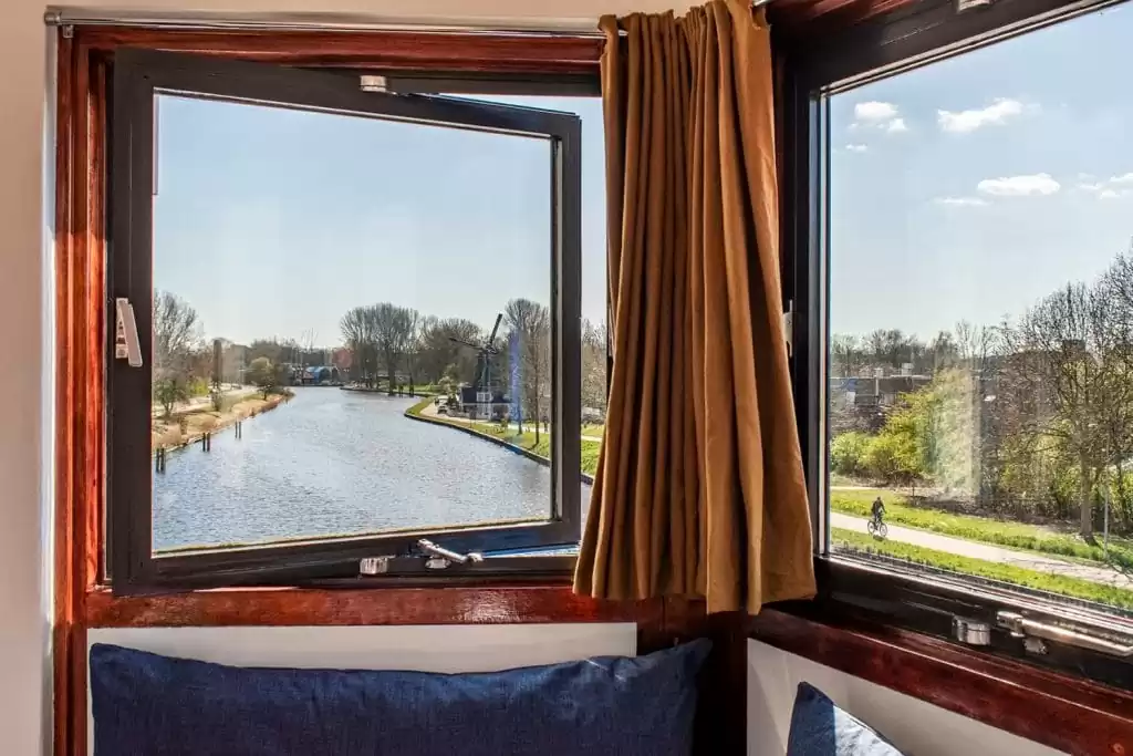 SWEETS hotel Amsterdam Noord Holland_bridge house 104 IJdoornlaanbrug_hotel interior_hotel view of dutch windmill