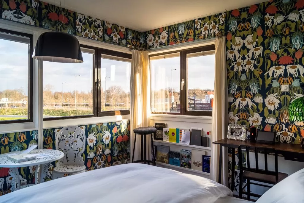 SWEETS hotel Amsterdam Noord_bridge house 102 Meeuwenpleinbrug_bedroom interior design by Studio Job_wallpaper table chair lamp_hotel view