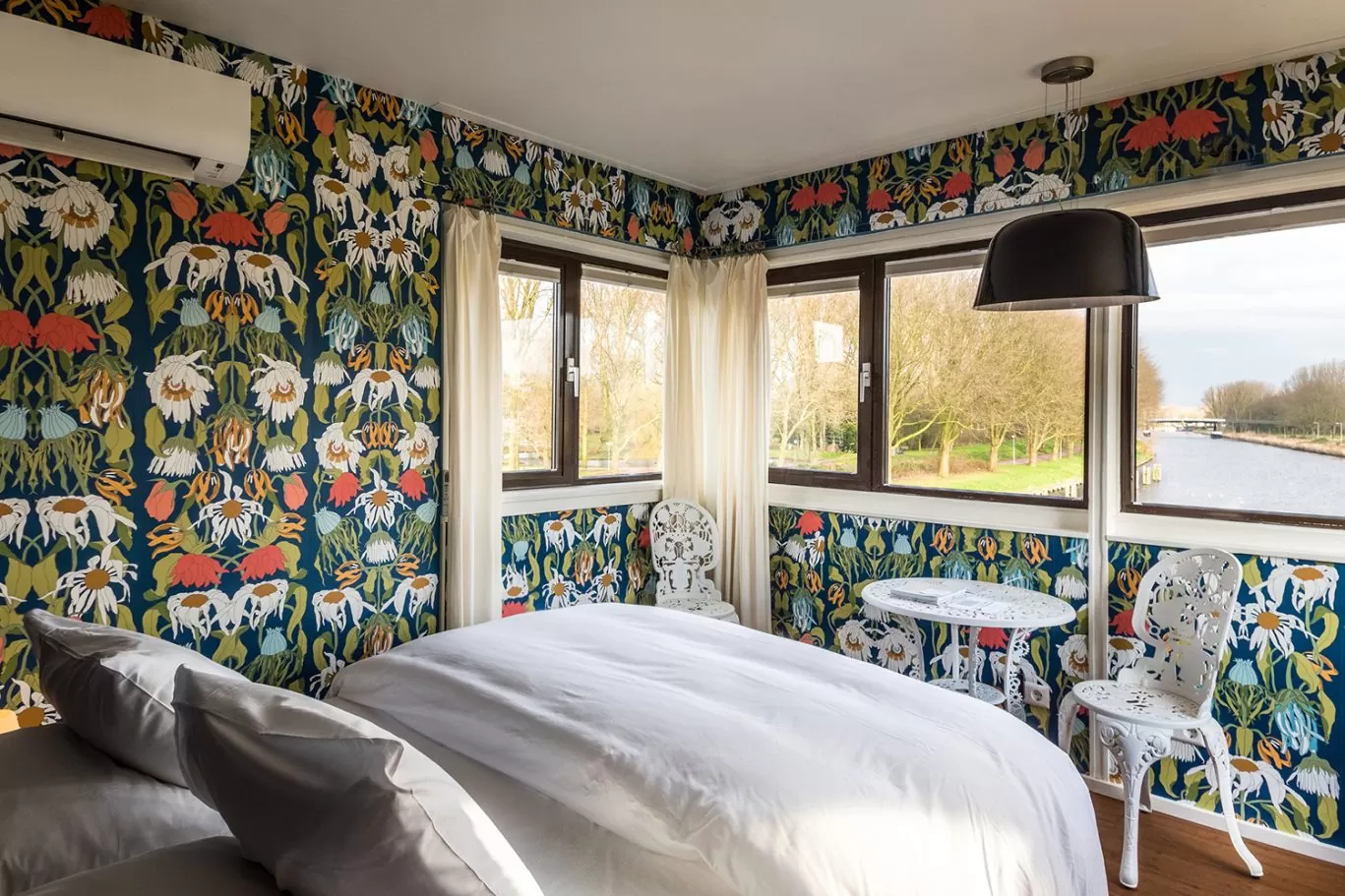 Interior of SWEETS hotel's bridge house 102 Meeuwenpleinbrug with flower wallpaper by Studio Job