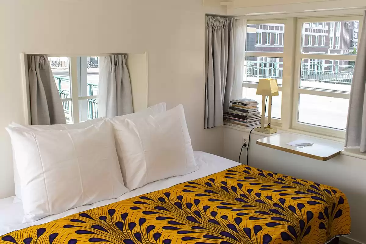 Photo of SWEETS hotel Amsterdam West Van Hallbrug bridge house interior hotel near Amsterdam Center bedroom bed street view dutch design lamp wannes royaards