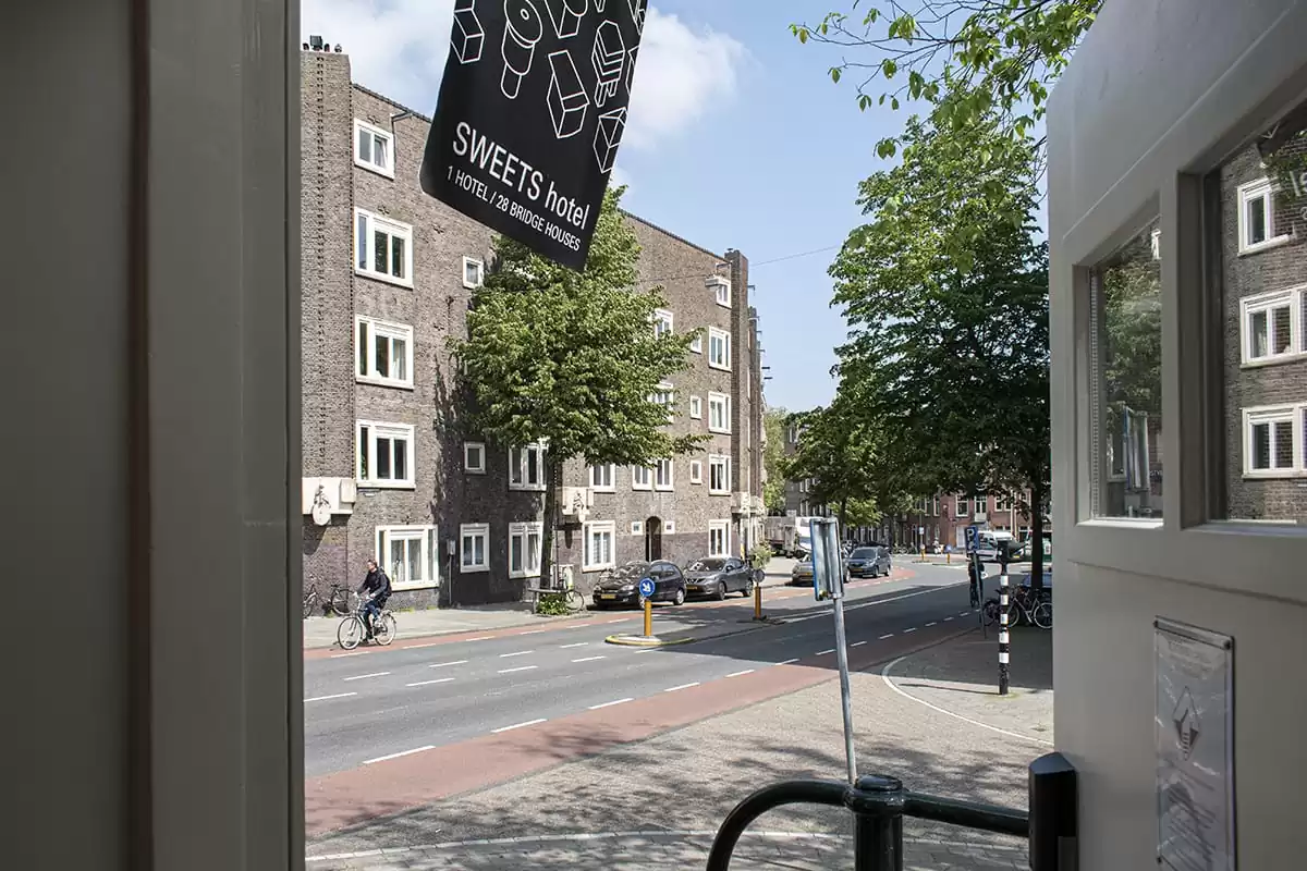 Photo of SWEETS hotel Amsterdam West Van Hallbrug bridge house interior hotel near Amsterdam Center street view cyclist flag