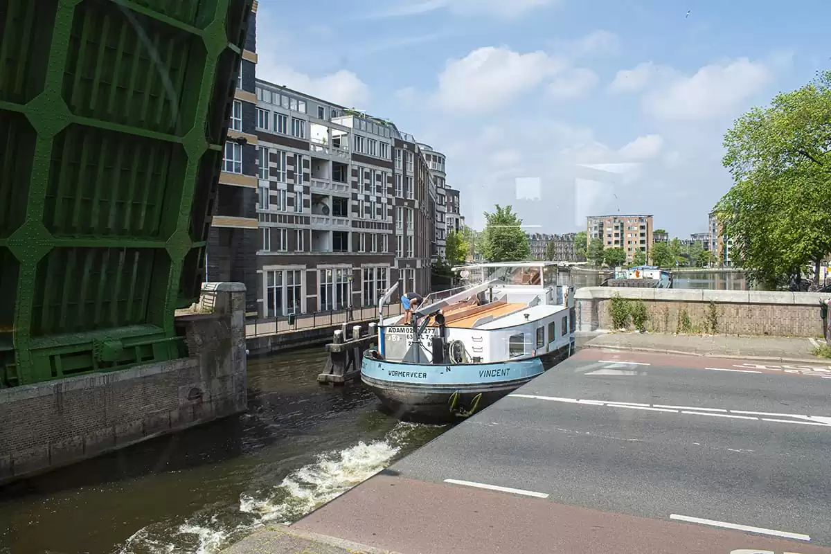 Photo of SWEETS hotel Amsterdam West Van Hallbrug bridge house interior hotel near Amsterdam Center view from bedroom bridge opening ship passing by street view