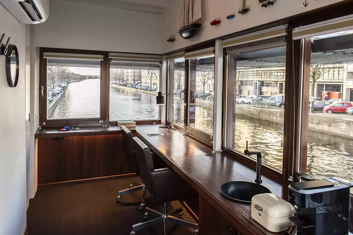 Photo of SWEETS hotel Amsterdam West Zeilstraatbrug bridge house interior living room area workspace facilities canal view