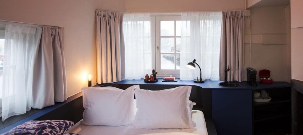 SWEETS hotel Beltbrug bridge house on Amsterdam canals next to windmill - design interior with Roos Soetekouw pillows and Studio Job lamp