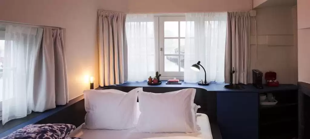 SWEETS hotel Beltbrug bridge house on Amsterdam canals next to windmill - design interior with Roos Soetekouw pillows and Studio Job lamp