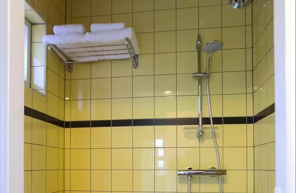 SWEETS hotel Beltbrug bridge house on Amsterdam canals - yellow bathroom with toilet and shower