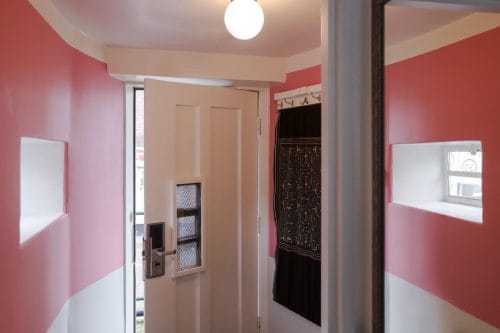 SWEETS hotel Kinkerbrug bridge house on Amsterdam canals - design interior with pink entrance close to Kinkerstraat and Ten Kate markt