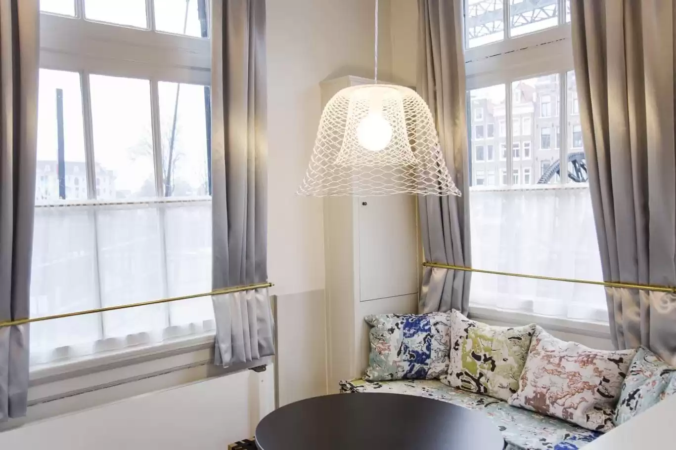SWEETS hotel Scharrebiersluis bridge house on Amsterdam canals - Gispen design table and handmade pillows Roos Soetekouw