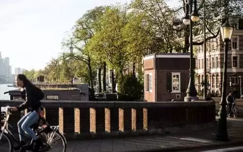 Photo of SWEETS hotel Amsterdam bridge house Nieuwe Amstelbrug surroundings exterior cyclist Amstel river